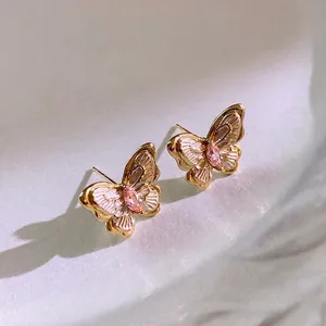 Elegant gold-plated butterfly stud earrings with pink gemstone and pearly white wings