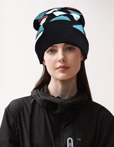 Detail view of rainbow knit beanie with colorful geometric patterns and ear protection