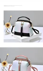 Detail of gradient macaron colored faux leather handbag with metal zipper and top handle