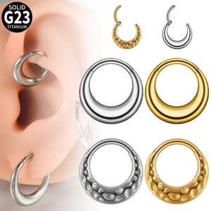 Polished and hammered G23 titanium clicker rings shown on ear model in gold and silver
