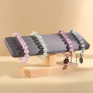 Solid wood tiered jewelry display stand showing colorful ice-cracked beaded bracelets
