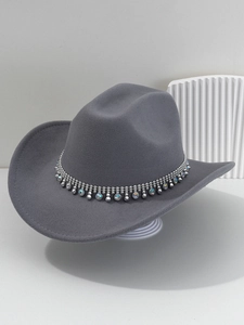 Detailed close-up of gray western cowboy hat with silver rhinestone and gemstone band decoration