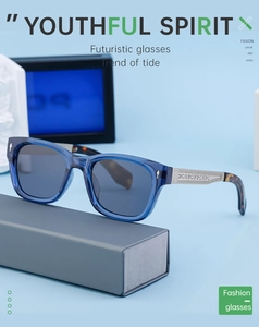 Detailed view of polarized sunglasses with blue transparent frame and engraved metal temple