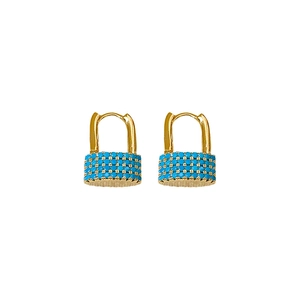 Minimalist gold oval lock earrings with blue zircon stones on a white background