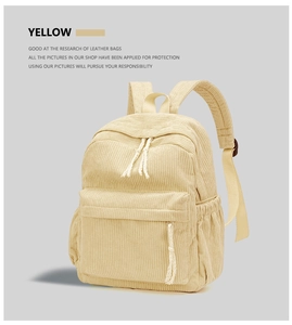 Close-up of yellow corduroy backpack showing fabric texture and zipper side pocket