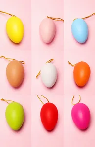 Detail view of 6cm colorful Easter egg pendants with gold hanging ropes in nine varied colors