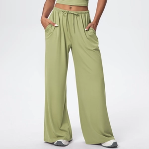 Detail of high waist drawstring and side pockets on green wide-leg lounge pants