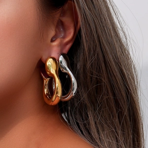 Chic oversized gold and silver hollow teardrop earrings worn by model for style view