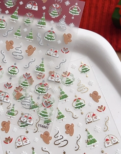 Detailed view of 3D Christmas nail art stickers with gingerbread man and snowflake patterns