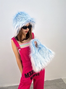 Detail shot of light blue faux fur bucket hat and matching plush handbag for winter