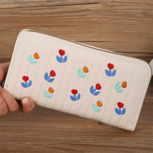 Detailed embroidery of colorful tulips and vertical stitching on beige long wallet