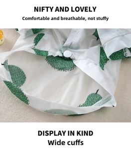 Detail showing breathable mesh fabric with fruit print and secure white snap buttons