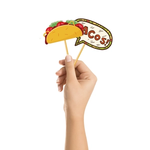 Close-up of a hand holding colorful Mexican Fiesta taco and Tacos speech bubble photo props