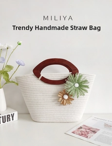 Detail of woven cotton rope bag with wood handle and handmade straw flower accents