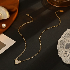 14K gold plated stainless steel heart necklace on elegant silk and lace background