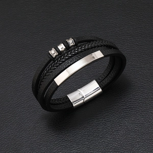 Multilayer hand-braided black leather bracelet with silver magnetic buckle on black background