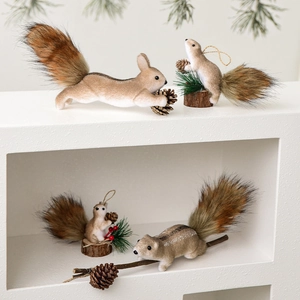 Brown fuzzy squirrel Christmas tree ornaments in four poses with pine cones and wood base