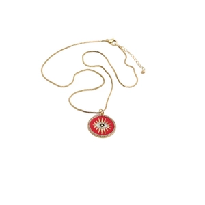 Close-up of gold plated box chain necklace with red enamel evil eye round pendant