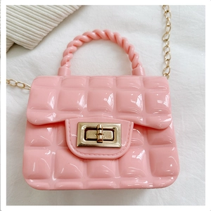 Macro detail of pink quilted jelly bag with golden turn-lock and twist handle