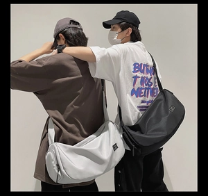 Black and light gray large waterproof nylon sports duffle bags shown on models for gym