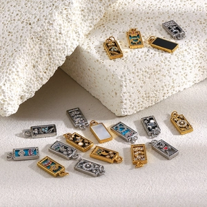 Macro view of gold and silver tarot card pendants including The Sun and The Star