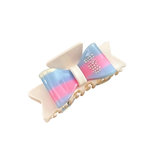 Blue and pink gradient bow hair claw clip with rhinestones on a white background