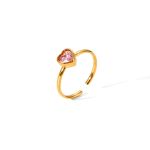 Macro shot of 18k gold plated open ring with heart shaped pink crystal gemstone