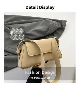 Detail of beige matte suede baguette bag with wide shoulder strap and gold buckle