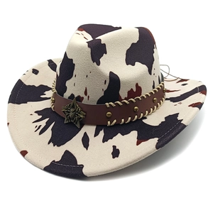 Cow print western cowboy hat with star buckle and leather band on white background