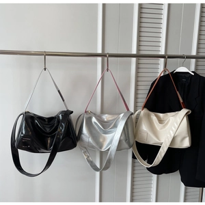 Three minimalist boston pillow bags in silver black and beige with glossy finish