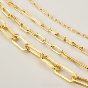 Macro detail of four assorted thicknesses of 925 silver gold plated paperclip chains