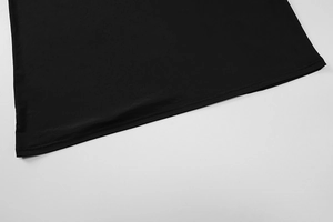 Close-up of black summer lace dress hemline showing smooth fabric texture and stitch details