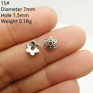 Macro detail of 7mm vintage silver daisy flower bead spacers with size measurements