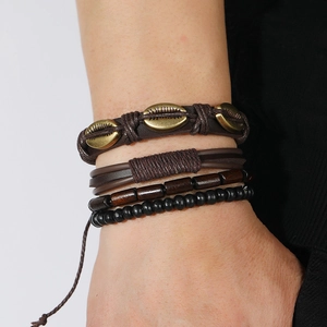 Layered bohemian bracelet set with brown woven leather, cowrie shell, and wood beads