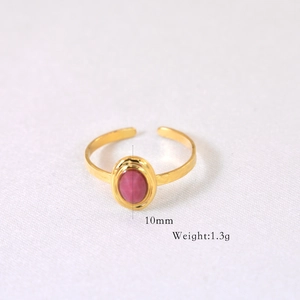 Close-up of golden stainless steel ring with 10mm pink oval stone and 1.3g weight