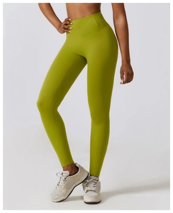 Detail of high waisted yoga pants in grass green with seamless moisture wicking fabric