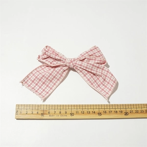 Pink and white checkered fabric bow hair clip, 15cm wide, displayed on a white background