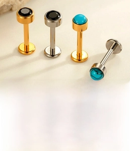 Detail of titanium labret studs with turquoise and black zircon stones in 1.2mm x 8mm size