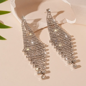 Macro shot of silver diamond-encrusted fringe earrings with sparkling tassel detail