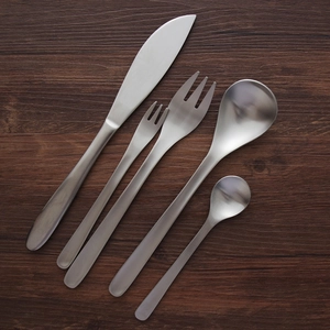 5-piece matte 304 stainless steel cutlery set with silver finish on dark wood table