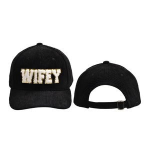 Detail of black corduroy baseball cap showing WIFEY chenille patch and adjustable metal buckle
