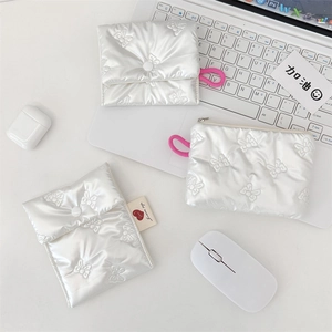 Detailed view of white quilted satin pouch with bow pattern and rose pink elastic cord