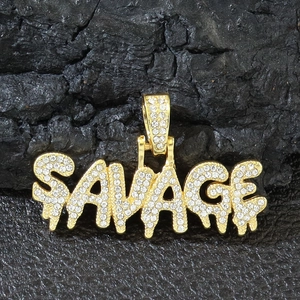 Iced-out gold SAVAGE letter pendant necklace with diamonds on a textured dark background