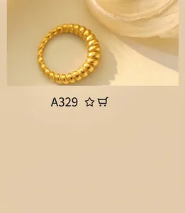 Detail of a 18K gold plated croissant style ring with twisted ridge texture and finish