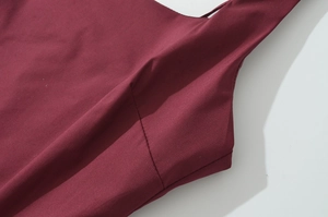 Close-up of the fine sewing and strap detail on a dark red French style vacation dress