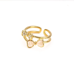 Detail of gold double-layer ring featuring a sparkling bow with cat eye stone inlay