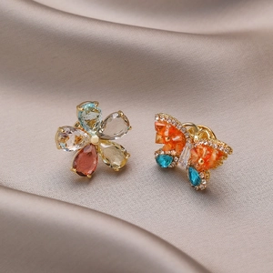Asymmetric flower and butterfly earrings with colorful crystals on champagne silk