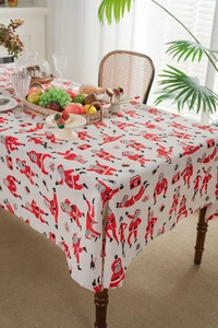 Close-up of dancing Santa print on beige linen Christmas tablecloth for holiday dining