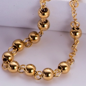 Close-up of a 6mm gold plated titanium steel bead necklace with polished metallic finish