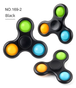 Detailed view of black three-leaf fidget spinner with colorful push pop silicone bubbles